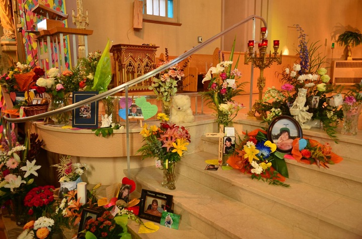 Flowers and tributes left on the altar of Ste-Agnès Church in Lac-Megantic, where the town is mourning the loss of 47 people. 
