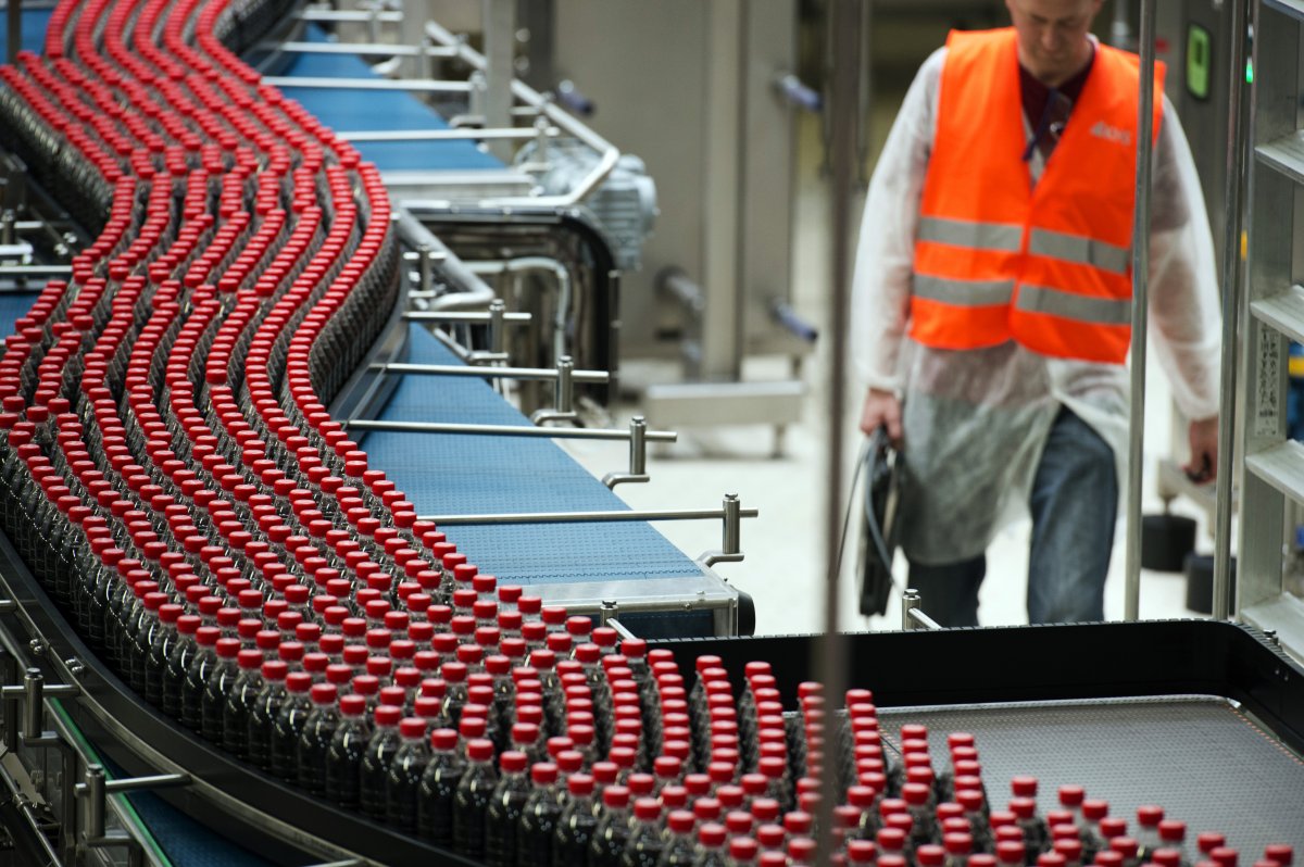 This photo taken on June 7, 2013, in Clamart, near Paris, shows newly produced Coca-Cola soft drink bottles on an assembly line at a Coca Cola bottling plant.