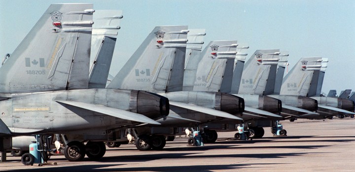  Canadian Air Force CF-18 Hornet jets are parked in a row on a runway at the Canadian Forces Base in Cold Lake, Alberta. 