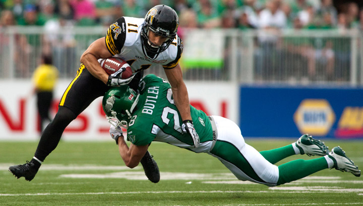 Saskatchewan Roughriders safety Craig Butler tackles Hamilton Tiger-Cats wide receiver Samuel Giguere during the second half of CFL football action at Mosaic Stadium on Sunday, July 21, 2013 in Regina.