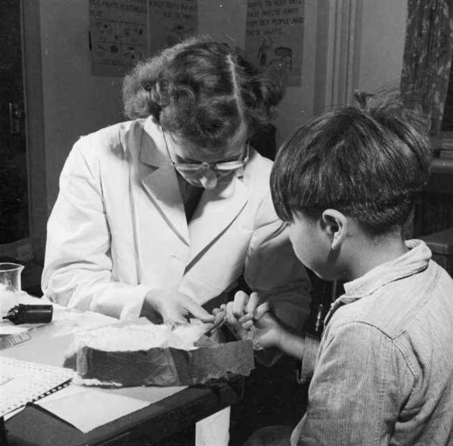 A nurse takes a blood sample from a boy at the Indian School, Port Alberni, B.C., in 1948, during the time when nutritional experiments were being conducted on students there and five other residential schools.