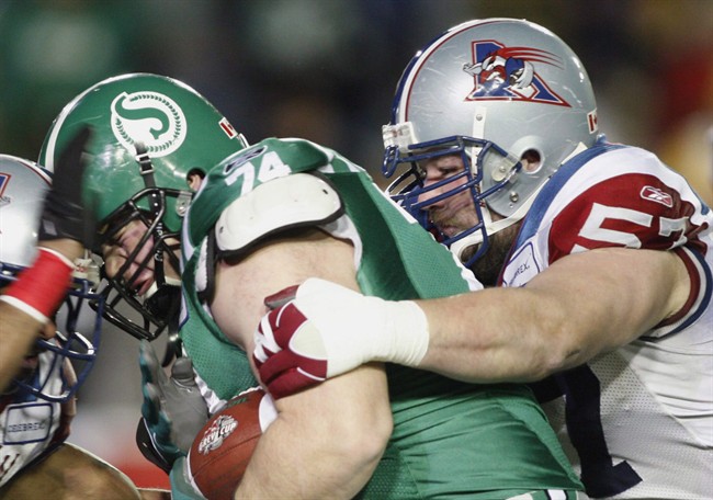 Montreal Alouettes running back Avon Cobourne (left) and guard Scott Flory (right) tackle Saskatchewan Roughriders defensive lineman Keith Shologan during first quarter Grey Cup action in Calgary, November 29, 2009. Montreal Alouettes offensive lineman Scott Flory will miss the remainder of the season after suffering a torn bicep.