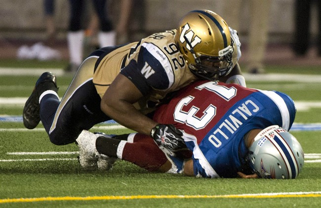 Former Winnipeg Blue Bombers defensive tackle Bryant Turner sacks Montreal Alouettes quarterback Anthony Calvillo in Montreal in July.