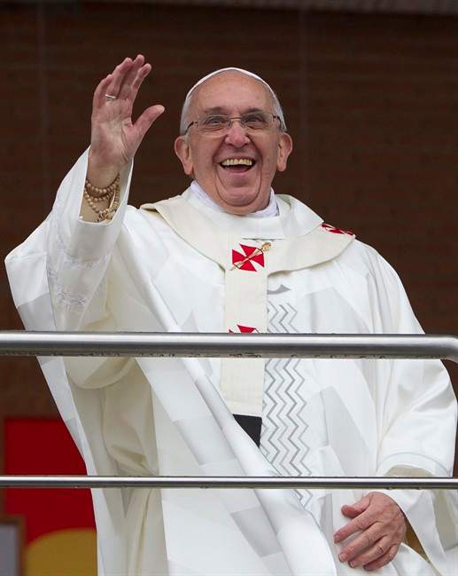Pope Francis waves to pilgrims as he stands on a balcony at the Aparecida Basilica after celebrating Mass in Aparecida, Brazil, Wednesday, July 24, 2013.