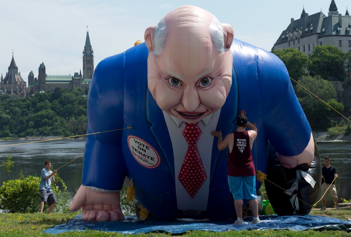 A giant Mike Duffy-shaped balloon is inflated near Parliament Hill Thursday July 18, 2013 in Ottawa. The balloon is part of a Senate reform campaign. THE CANADIAN PRESS/Adrian Wyld.