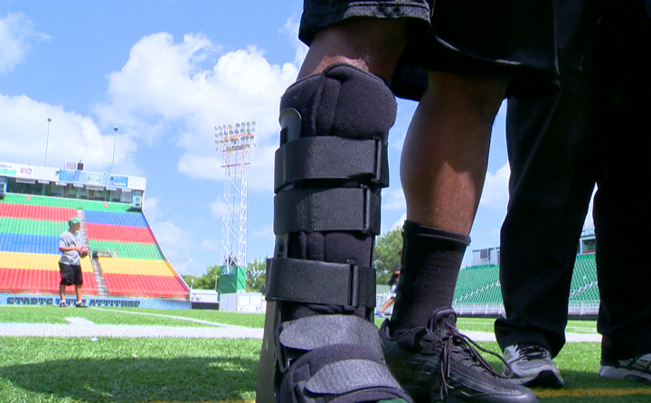 Saskatchewan Roughriders' quarterback Durant back wearing walking boot on injured foot.