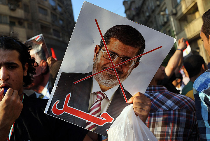 An anti-President Mohammed Morsi poster is viewed as as thousands of Egyptian protesters celebrate in Tahrir Square as the deadline given by the military to Egyptian President Mohammed Morsi passes on July 3, 2013 in Cairo, Egypt. 
