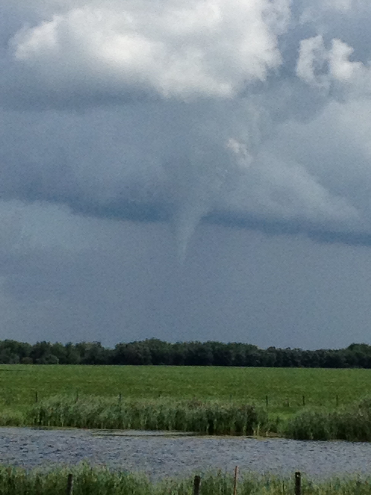 A funnel cloud forms east of Morris, Man., at about 2:30 p.m. Wednesday. Environment Canada confirmed a tornado touched down in the area at about 2:45 p.m.