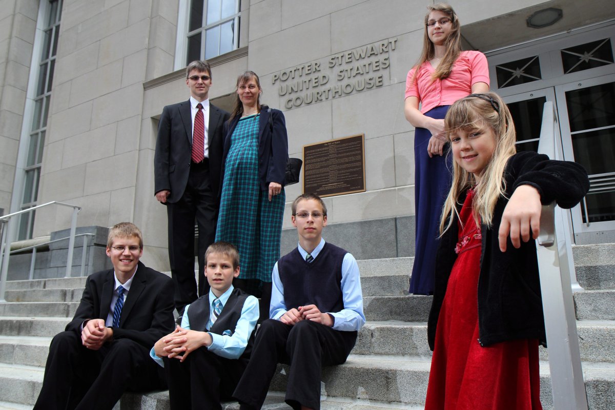 Uwe and mother Hannolure Romeike with their children, Daniel, 16, Joshua, 13, Christian, 11, Lydia, 15 and Damaris, 7, left to right, pose for photos outside the federal courthouse in Cincinnati Tuesday, April 23, 2013. A federal appeals court is weighing whether the Romeike family, from Germany but now live in Morristown, Tenn. and home-school their children, should be granted asylum and be allowed to continue living in Tennessee. (.