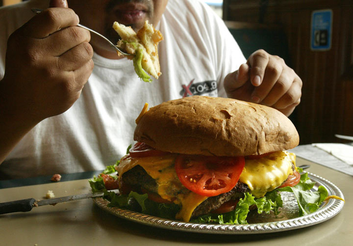 Will skipping the bun make my burger healthier? (Photo credit: JEFF HAYNES/AFP/Getty Images)