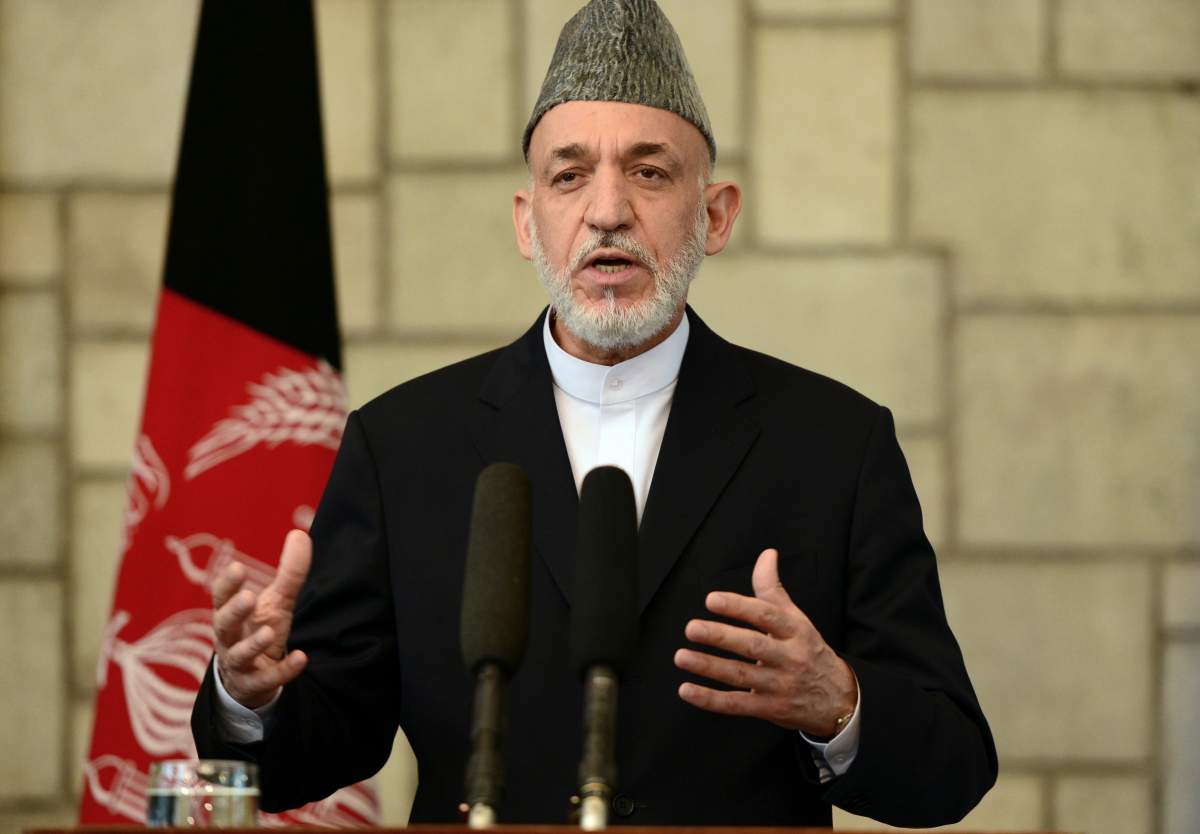 Afghan President Hamid Karzai talks during a joint press conference with British Prime Minister David Cameron at the Presidential Palace in Kabul on June 29, 2013. British Prime Minister David Cameron made an unannounced visit to Afghanistan on June 29, backing talks with the Taliban as his top general said the West missed a chance to strike a peace deal 10 years ago.