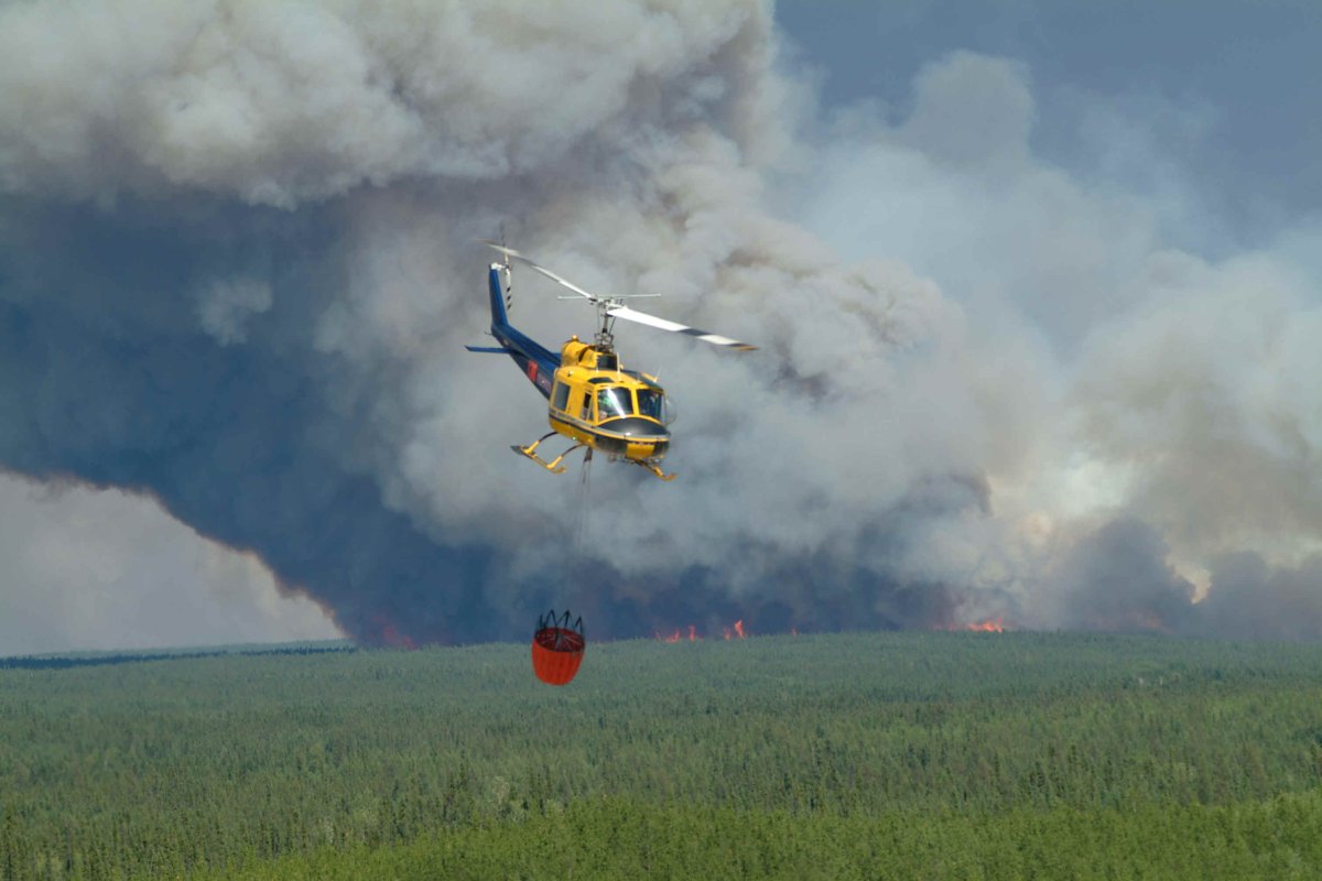 A helicopter drops water on a fire in this file photo.
