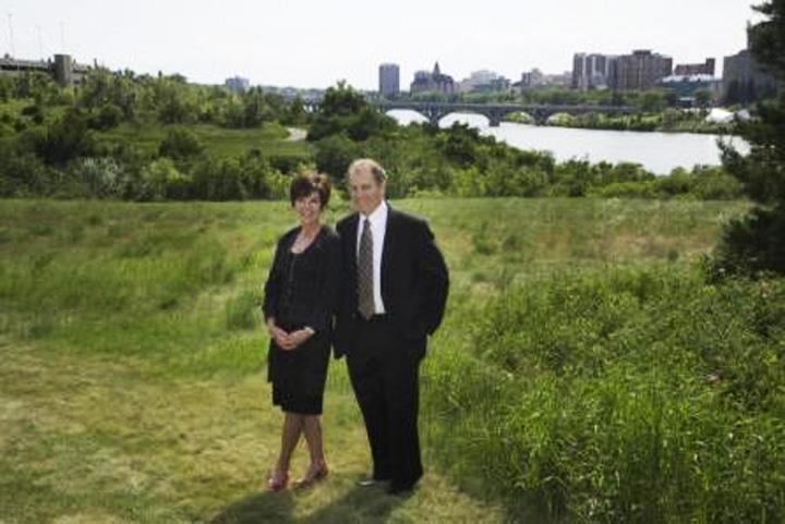 Mary Ellen (left) and husband Ian Buckwold (right) posing for photo on the riverbank for the “The Future in Mind Campaign” in Saskatoon.