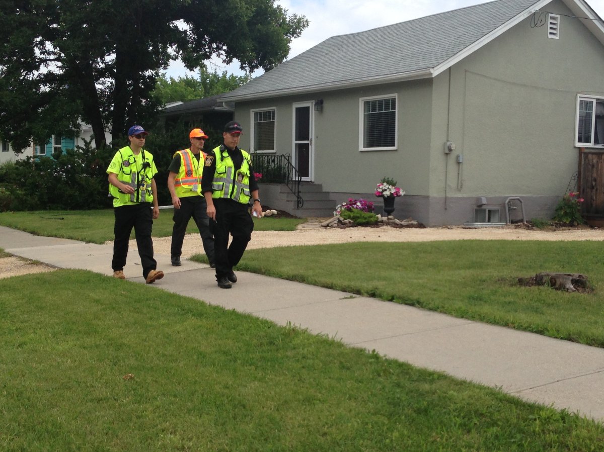 Police and search crews on a street in the Winnipeg neighbourhood of Westwood Thursday, as part of the search for Lisa Gibson.