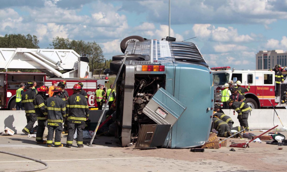 Firefighters work to extricate people from a bus crash Saturday, July 27, 2013 in Indianapolis. The Indianapolis Fire Department says three people were killed when a bus carrying teens from a church camp crashed on a busy thoroughfare near Interstate 465. The bus was carrying 40 passengers who are members of Colonial Hill Baptist Church and were returning from camp when the crash happened Saturday afternoon. 