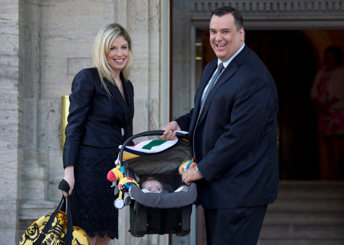 James Moore and his wife Courtney Payne stop with their child, Spencer, as they arrive for a cabinet shuffle at Rideau Hall in Ottawa on July 15, 2013. Moore was sworn in as minister of industry. 
