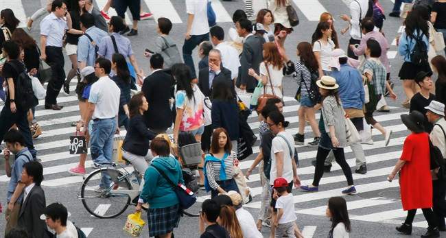  People cross the street in Tokyo, Monday, July 1, 2013.