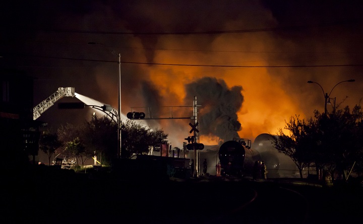 Firefighters douse blazes after a freight train loaded with oil derailed in Lac-Megantic, Que. on July 6, sparking explosions that engulfed about 30 buildings in fire. 