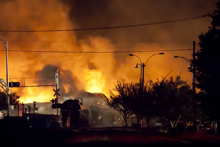 Firefighters douse blazes after a freight train loaded with oil derailed in Lac-Megantic in Canada's Quebec province on July 6, 2013, sparking explosions that engulfed about 30 buildings in fire. 