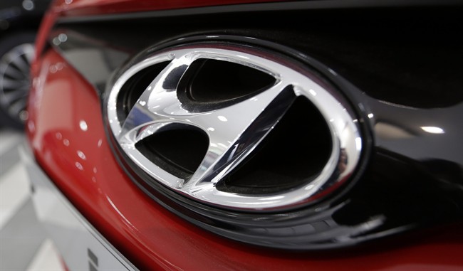 The logo of Hyundai Motor Co. is seen on a car at its showroom in Seoul, South Korea, Thursday, July 25, 2013.