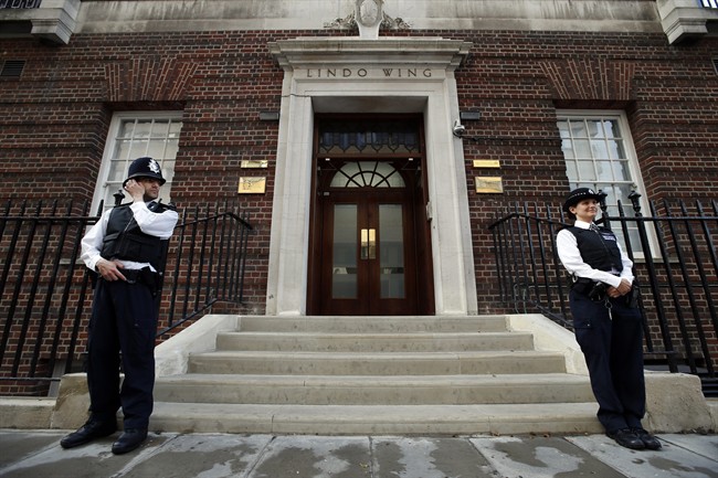 British police officers guard the entrance of St. Mary's Hospital exclusive Lindo Wing in London, Monday, July 22, 2013.