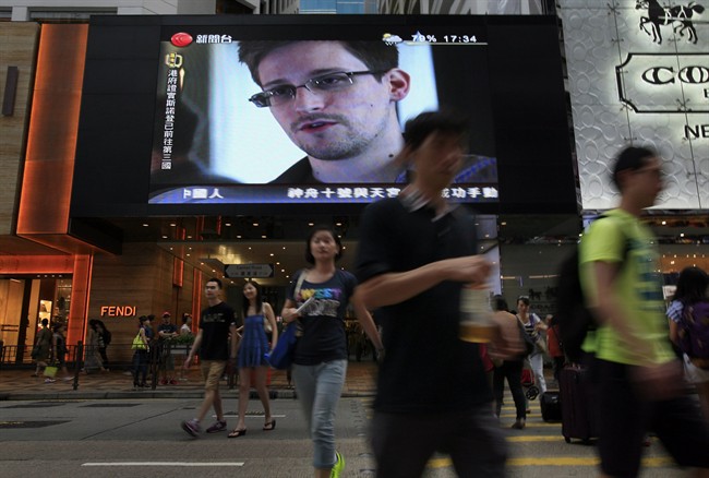 FILE - This June 23, 2013 file photo shows a TV screen shows a news report of Edward Snowden, a former CIA employee who leaked top-secret documents about sweeping U.S. surveillance programs, at a shopping mall in Hong Kong. The saga of Edward Snowden and the NSA makes one thing clear: The United States' central role in developing the Internet and hosting its most powerful players has made it the global leader in the surveillance game . Other countries, from dictatorships to democracies, are also avid snoopers, tapping into the high-capacity fiber optic cables to intercept Internet traffic, scooping their citizens' data off domestic servers, and even launching cyberattacks to win access to foreign networks. 