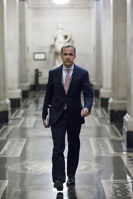 Mark Carney, the new Governor of the Bank of England, walks to a monetary policy committee (MPC) briefing on his first day on the job inside the central bank's headquarters in London Monday July 1, 2013.