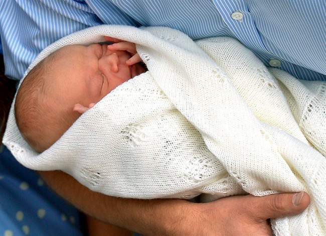 In this Tuesday, July 23, 2013 file photo, Britain\’s Prince William carries his new born son, the Prince of Cambridge into public view for the first time. outside the Lindo Wing of St. Mary\’s Hospital, in London.