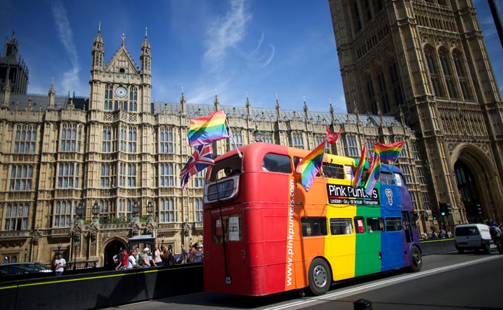 Campaigners drive a bus past the Houses of Parliament as the Marriage (Same Sex Couples) Bill gets an unopposed third reading by the Lords in central London on July 15, 2013. 