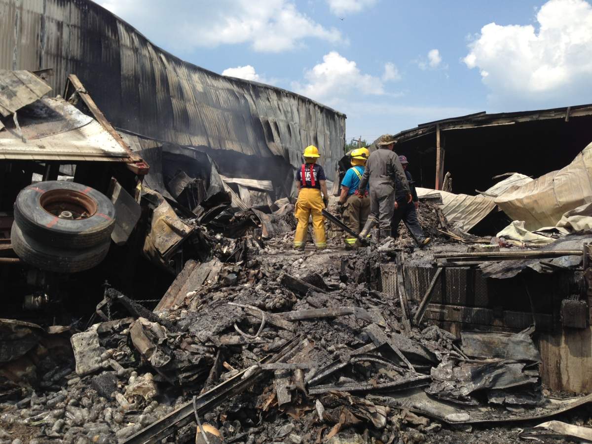 The ruins of a bottled-water plant in Middlebro, Man., smoulders on Tuesday.