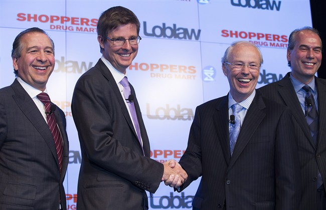 Domenic Pilla, president and CEO of Shoppers Drug Mart Corporation; left to right, along Galen Weston Jr., executive chairman of Loblaw Co. Ltd.; Holger Kluge, chair of Shoppers Drug Mart Corporation; and Vicente Trius president of Loblaw Co. Ltd., pose for a photo at a press conference announcing that Loblaw Companies Limited will acquire Shoppers Drug Mart Corporation for $12.4 billion in cash and stock in Toronto on Monday, July 15, 2013.