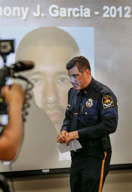Omaha Police Chief Todd Schmaderer walks past a photo of Anthony Garcia after speaking at a news conference at police headquarters in Omaha, Neb., Monday, July 15, 2013. 