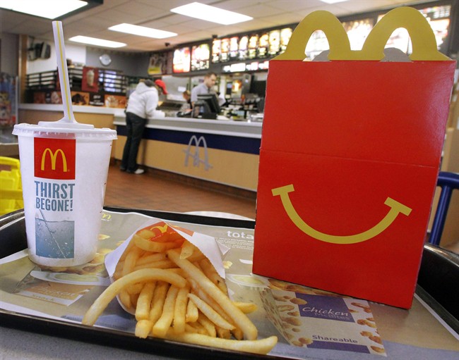 In this Jan. 20, 2012 photo, the McDonald's logo and a Happy Meal box with french fries and a drink are posed at McDonald's.