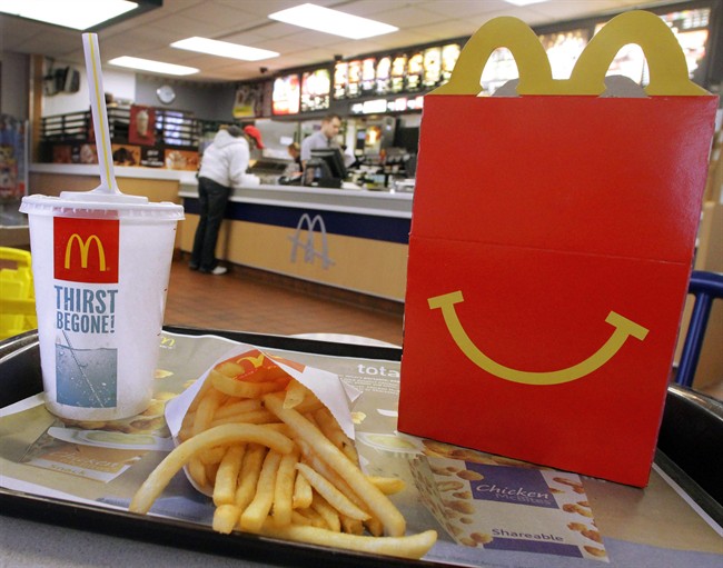 In this Jan. 20, 2012 photo, the McDonald's logo and a Happy Meal box with french fries and a drink are posed at McDonald's, in Springfield, Ill. McDonald’s Corp. reports quarterly earnings on Monday, July 22, 2013. (AP Photo/Seth Perlman)