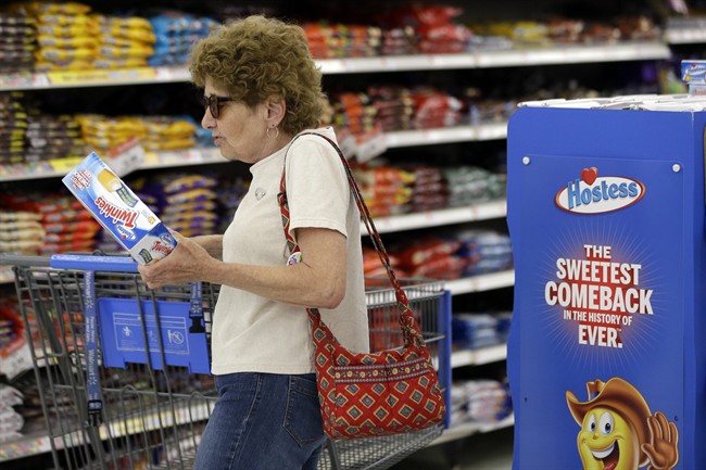 In this Friday, July 12, 2013, file photo Jo Mullen picks up a box of Twinkies at Wal-Mart, in Bristol, Pa.