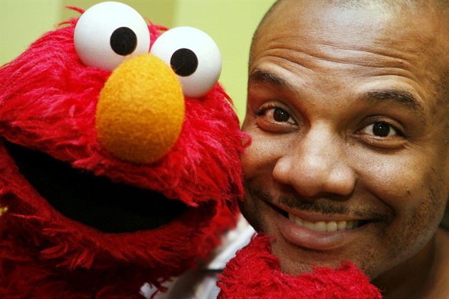 This Aug 16, 2006 file photo shows Kevin Clash, who was the voice and movements behind Sesame Street's Elmo, posing for a picture with Elmo in New York. 