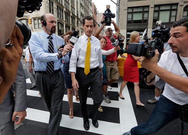New York City mayoral candidate Anthony Weiner is pursued by reporters after leaving his apartment in New York on Wednesday, July 24, 2013.