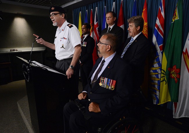 Veteran Michael Blais, President and founder of Canadian Veterans Advocacy, clockwise from left, Veteran Carlos Robert Steiner, NDP Deputy Veterans Affairs Critic Sylvain Chicoine, NDP Veterans Affairs Critic Peter Stoffer and Veteran David Desjardins take part in a press conference on Parliament Hill in Ottawa on Tuesday, July 30, 2013.