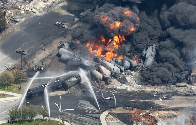 Smoke rises from railway cars that were carrying crude oil after derailing in downtown Lac Megantic, Que., Saturday, July 6, 2013.
