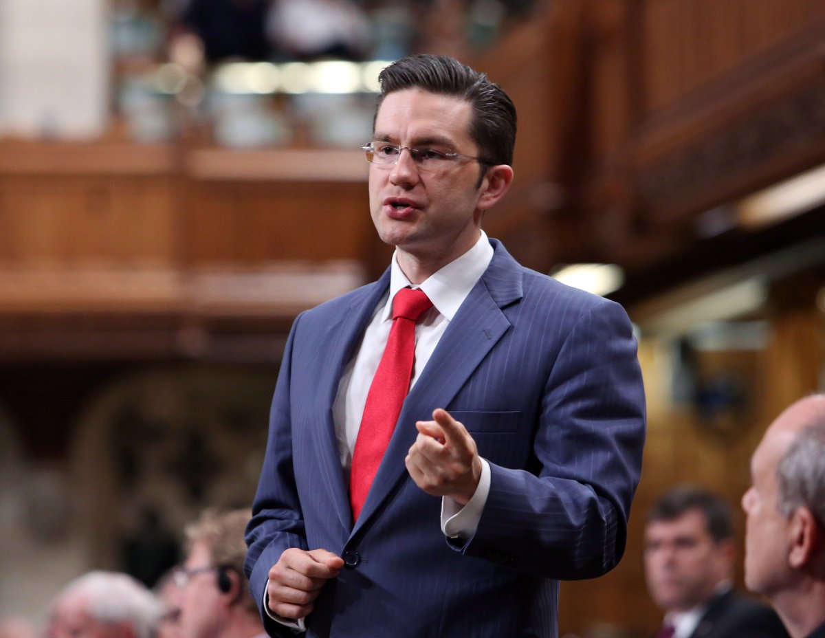 Conservative MP Pierre Poilievre stands in the House of Commons during question period in Ottawa Friday May 24, 2013. 