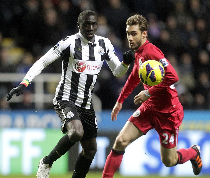 Newcastle United's Senegalese striker, Papiss Cisse (L) vies with Wigan Athletic's Spanish defender Adrian Lopez (R) during their English Premier League football match at St James Park, Newcastle upon Tyne, England, on December 3, 2012.