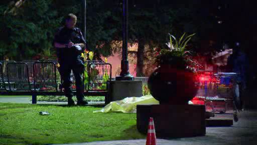 Police investigate the death of a man at Olympic Plaza late Friday night.