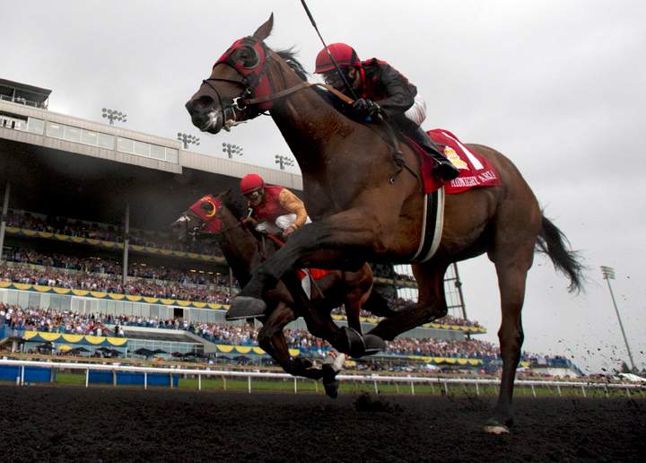 Jesse Campbell rides Midnight Aria, front, to edge out Eurico Rosa da Silva aboard Up With The Birds to win the 154th Queen's Plate at Woodbine Racetrack in Toronto on Sunday, July 7, 2013.
