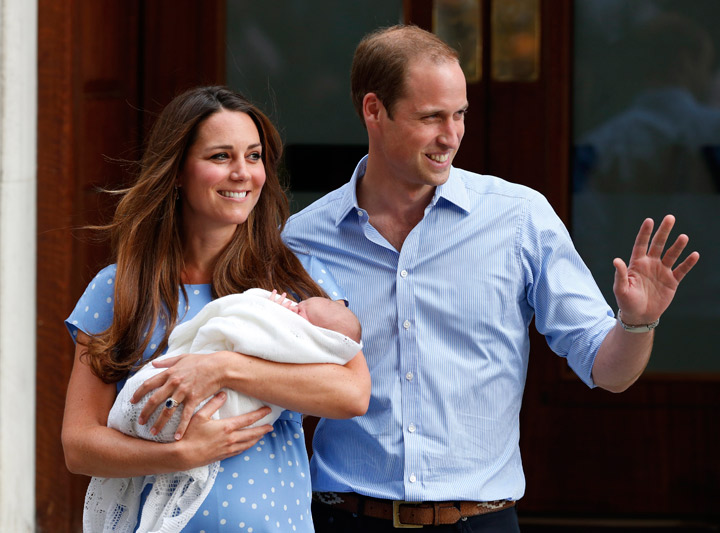Britain's Prince William and Kate, Duchess of Cambridge hold the Prince of Cambridge, Tuesday July 23, 2013, as they pose for photographers outside St. Mary's Hospital exclusive Lindo Wing in London where the Duchess gave birth on Monday July 22. 