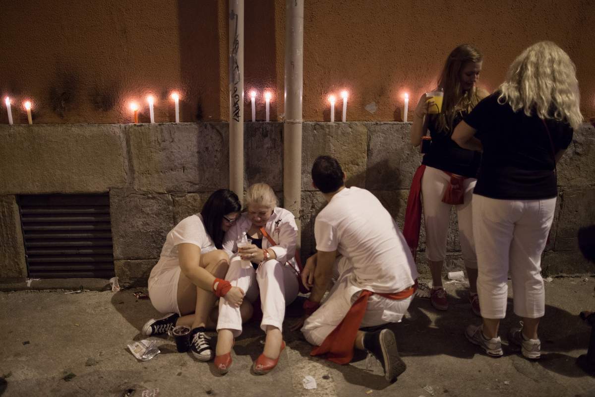 PAMPLONA, SPAIN - JULY 15: Revellers get overcome by emotion after ceremony of the 'Pobre de Mi' that marked the end of the San Fermin festival on July 15, 2013 in Pamplona, Spain. The annual Fiesta de San Fermin, made famous by the 1926 novel of US writer Ernest Hemmingway 'The Sun Also Rises', involves the running of the bulls through the historic heart of Pamplona, this year for nine days from July 6-14. 