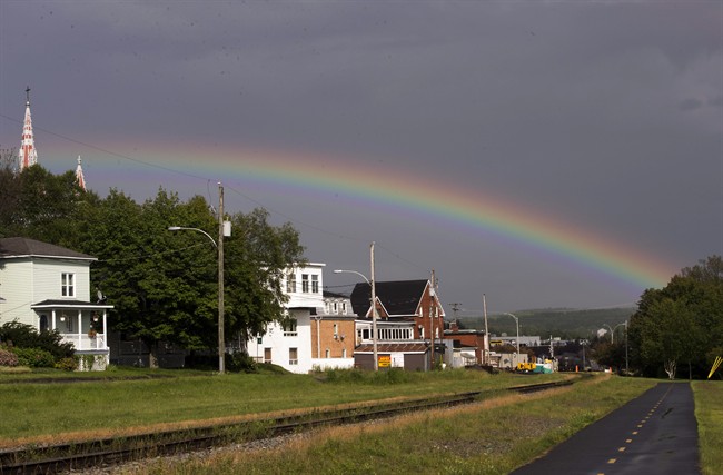 A rainbow arcs over the crash site Tuesday, July 9, 2013 in Lac-Megantic, Que.