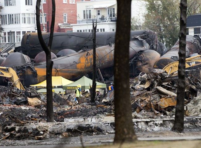 Work underway at the crash site of the train derailment and fire in Lac-Megantic, Que. that left dozens dead.(Ryan Remiorz/The Canadian Press)