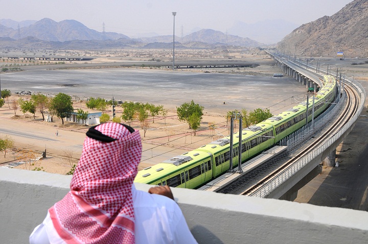 A man stands watching the newly-opened Holy Sites metro light rail in the western Saudi city of Mecca on November 2, 2010. 