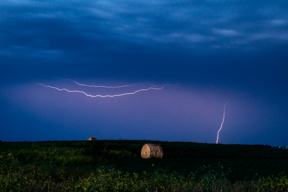 Lightning flashes as the storm rolls in over the Red River Floodway on the outskirts of Winnipeg last night.