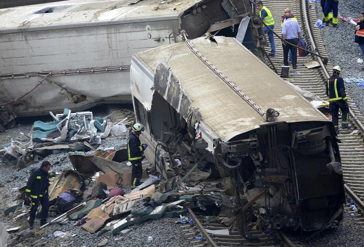 Rescuers check a car at the site of a train accident near the city of Santiago de Compostela on July 25, 2013. 